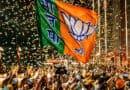 BJP flag waving at a political rally during election celebrations.